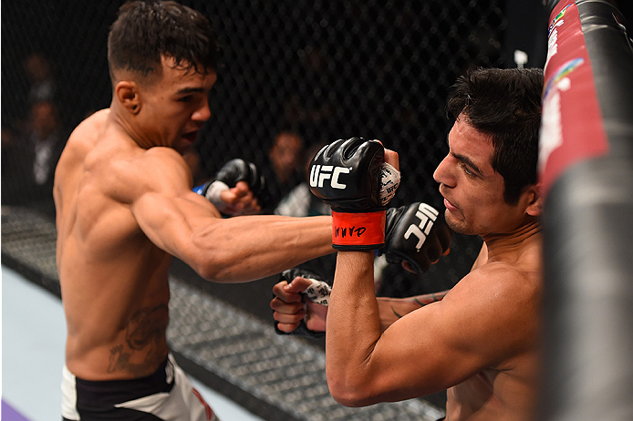 MONTERREY, MEXICO - NOVEMBER 21:  (L-R) Andre Fili of the United States punches Gabriel Benitez of Mexico in their featherweight bout during the UFC Fight Night event at Arena Monterrey on November 21, 2015 in Monterrey, Mexico.  (Photo by Jeff Bottari/Zu