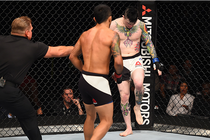 MONTERREY, MEXICO - NOVEMBER 21:  (R-L) Scott Jorgensen of the United States limps in pain as his leg is injured against Alejandro Perez of Mexico in their bantamweight bout during the UFC Fight Night event at Arena Monterrey on November 21, 2015 in Monte