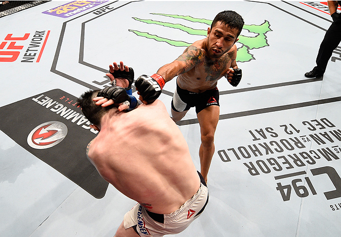 MONTERREY, MEXICO - NOVEMBER 21:  (R-L) Alejandro Perez of Mexico punches Scott Jorgensen of the United States in their bantamweight bout during the UFC Fight Night event at Arena Monterrey on November 21, 2015 in Monterrey, Mexico.  (Photo by Jeff Bottar