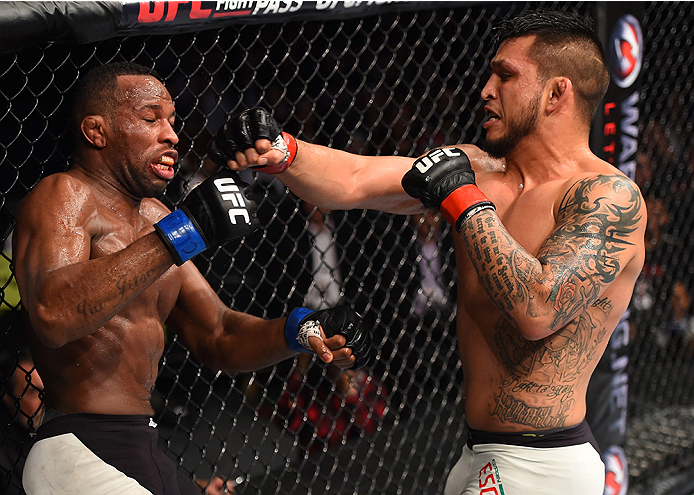 MONTERREY, MEXICO - NOVEMBER 21:  (R-L) Efrain Escudero of Mexico punches Leandro Silva of Brazil in their lightweight bout during the UFC Fight Night event at Arena Monterrey on November 21, 2015 in Monterrey, Mexico.  (Photo by Jeff Bottari/Zuffa LLC/Zu