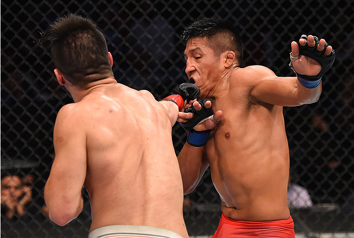 MONTERREY, MEXICO - NOVEMBER 21:  (L-R) Horacio Gutierrez of Mexico punches Enrique Barzola of Peru in their lightweight bout during the UFC Fight Night event at Arena Monterrey on November 21, 2015 in Monterrey, Mexico.  (Photo by Jeff Bottari/Zuffa LLC/