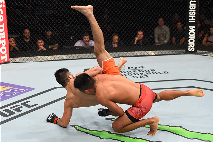 MONTERREY, MEXICO - NOVEMBER 21: (R-L) Enrique Barzola of Peru takes down Horacio Gutierrez of Mexico in their lightweight bout during the UFC Fight Night event at Arena Monterrey on November 21, 2015 in Monterrey, Mexico. (Photo by Jeff Bottari/Zuffa L