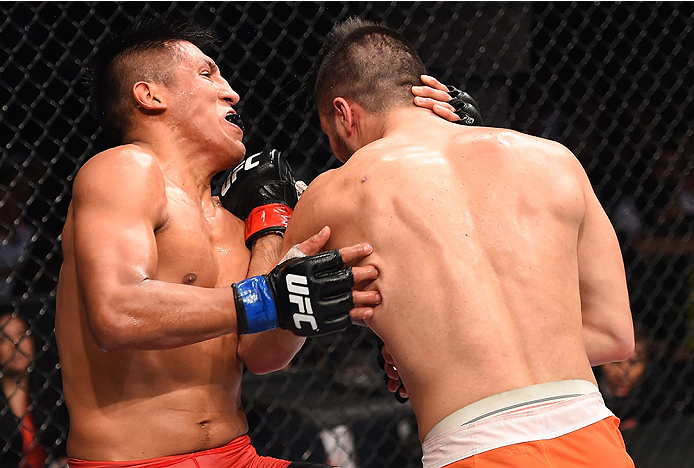 MONTERREY, MEXICO - NOVEMBER 21:  (R-L) Horacio Gutierrez of Mexico punches Enrique Barzola of Peru in their lightweight bout during the UFC Fight Night event at Arena Monterrey on November 21, 2015 in Monterrey, Mexico.  (Photo by Jeff Bottari/Zuffa LLC/