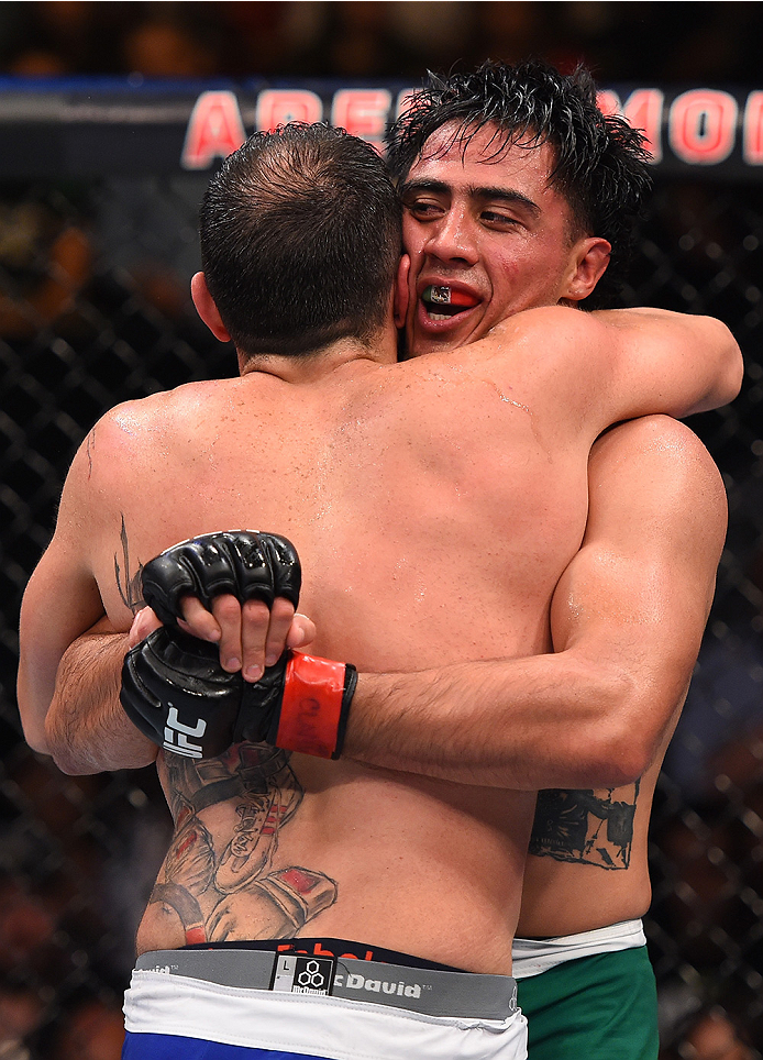 MONTERREY, MEXICO - NOVEMBER 21:  (R-L) Opponents Erick Montano of Mexico and Enrique Marin of Spain hug after the conclusion of their welterweight bout during the UFC Fight Night event at Arena Monterrey on November 21, 2015 in Monterrey, Mexico.  (Photo