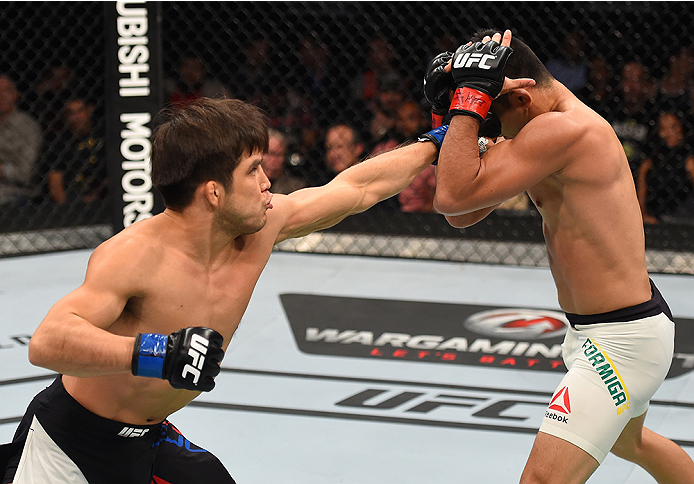 MONTERREY, MEXICO - NOVEMBER 21: (L-R) Henry Cejudo of the United States punches Jussier Formiga of Brazil in their flyweight bout during the UFC Fight Night event at Arena Monterrey on November 21, 2015 in Monterrey, Mexico. (Photo by Jeff Bottari/Zuff