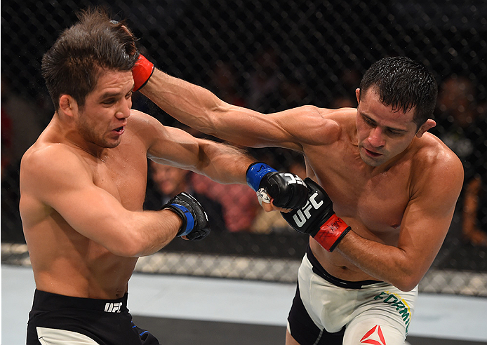 MONTERREY, MEXICO - NOVEMBER 21: (R-L) Jussier Formiga of Brazil punches Henry Cejudo of the United States in their flyweight bout during the UFC Fight Night event at Arena Monterrey on November 21, 2015 in Monterrey, Mexico. (Photo by Jeff Bottari/Zuff