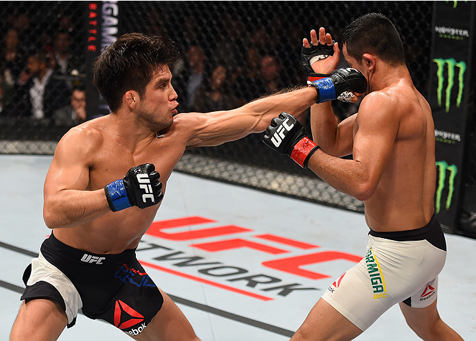 MONTERREY, MEXICO - NOVEMBER 21: (L-R) Henry Cejudo of the United States punches Jussier Formiga of Brazil in their flyweight bout during the UFC Fight Night event at Arena Monterrey on November 21, 2015 in Monterrey, Mexico. (Photo by Jeff Bottari/Zuff