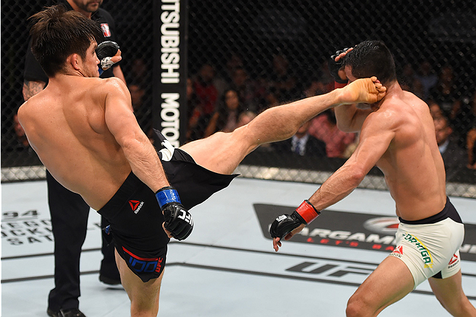 MONTERREY, MEXICO - NOVEMBER 21: (L-R) Henry Cejudo of the United States kicks Jussier Formiga of Brazil in their flyweight bout during the UFC Fight Night event at Arena Monterrey on November 21, 2015 in Monterrey, Mexico. (Photo by Jeff Bottari/Zuffa