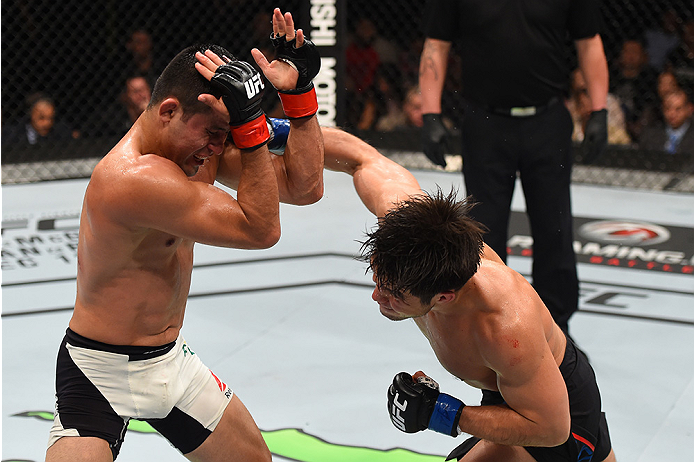 MONTERREY, MEXICO - NOVEMBER 21: (R-L) Henry Cejudo of the United States punches Jussier Formiga of Brazil in their flyweight bout during the UFC Fight Night event at Arena Monterrey on November 21, 2015 in Monterrey, Mexico.  (Photo by Jeff Bottari/Zuffa