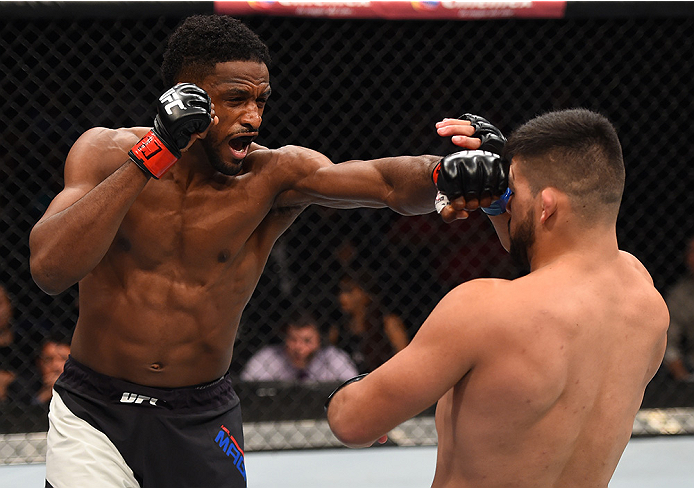 MONTERREY, MEXICO - NOVEMBER 21: (L-R) Neil Magny of the United States punches Kelvin Gastelum of the United States in their welterweight bout during the UFC Fight Night event at Arena Monterrey on November 21, 2015 in Monterrey, Mexico.  (Photo by Jeff B