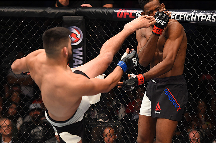 MONTERREY, MEXICO - NOVEMBER 21:  (L-R) Kelvin Gastelum of the United States kicks Neil Magny of the United States in their welterweight bout during the UFC Fight Night event at Arena Monterrey on November 21, 2015 in Monterrey, Mexico.  (Photo by Jeff Bo