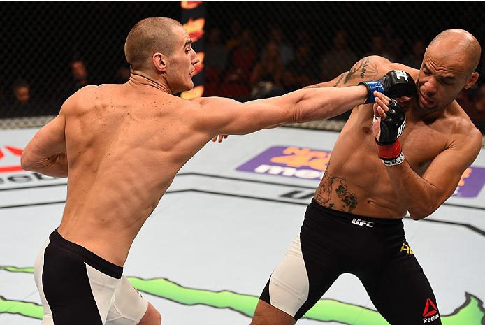 SAN DIEGO, CA - JULY 15:   (L-R) Sean Strickland punches Igor Araujo of Brazil in their welterweight bout during the UFC event at the Valley View Casino Center on July 15, 2015 in San Diego, California. (Photo by Jeff Bottari/Zuffa LLC/Zuffa LLC via Getty