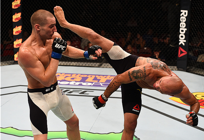 SAN DIEGO, CA - JULY 15: (R-L) Igor Araujo of Brazil kicks Sean Strickland in their welterweight bout during the UFC event at the Valley View Casino Center on July 15, 2015 in San Diego, California. (Photo by Jeff Bottari/Zuffa LLC/Zuffa LLC via Getty I
