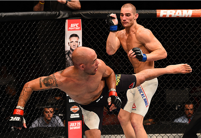 SAN DIEGO, CA - JULY 15:   (L-R) Igor Araujo of Brazil kicks Sean Strickland in their welterweight bout during the UFC event at the Valley View Casino Center on July 15, 2015 in San Diego, California. (Photo by Jeff Bottari/Zuffa LLC/Zuffa LLC via Getty I