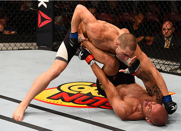 SAN DIEGO, CA - JULY 15: Sean Strickland (top) punches Igor Araujo of Brazil in their welterweight bout during the UFC event at the Valley View Casino Center on July 15, 2015 in San Diego, California. (Photo by Jeff Bottari/Zuffa LLC/Zuffa LLC via Getty