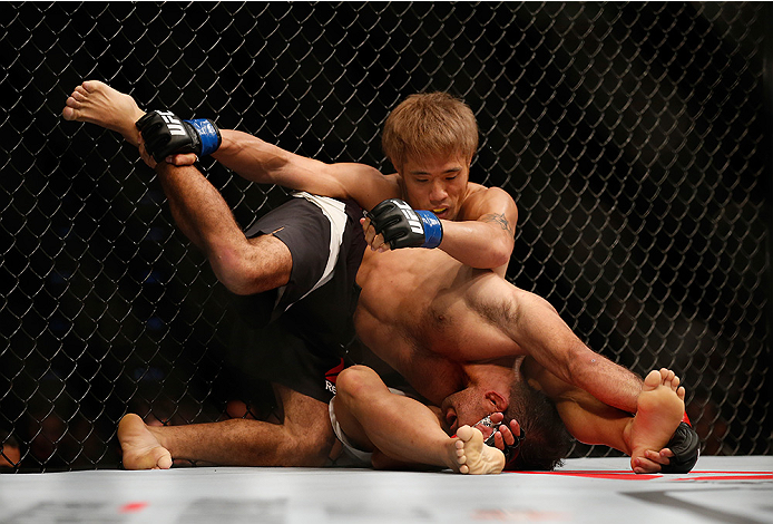 SAN DIEGO, CA - JULY 15:  (L-R) Rani Yahya of Brazil controls the body of Masanori Kanehara of Japan in their bantamweight bout during the UFC event at the Valley View Casino Center on July 15, 2015 in San Diego, California. (Photo by Todd Warshaw/Zuffa L