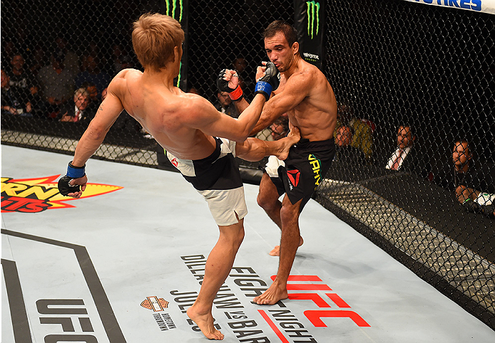 SAN DIEGO, CA - JULY 15: (L-R) Masanori Kanehara of Japan kicks Rani Yahya of Brazil in their bantamweight bout during the UFC event at the Valley View Casino Center on July 15, 2015 in San Diego, California. (Photo by Jeff Bottari/Zuffa LLC/Zuffa LLC vi