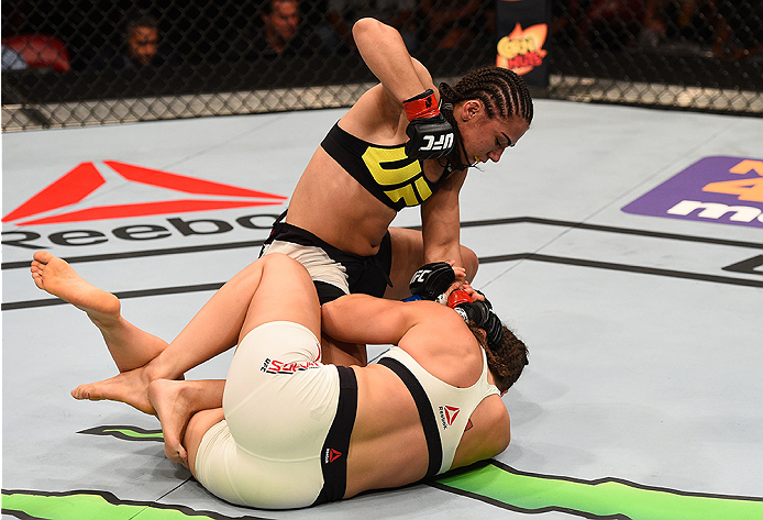 SAN DIEGO, CA - JULY 15:   Jessica Andrade (top) of Brazil punches Sarah Moras of Canada in their women's bantamweight bout during the UFC event at the Valley View Casino Center on July 15, 2015 in San Diego, California. (Photo by Jeff Bottari/Zuffa LLC/Z