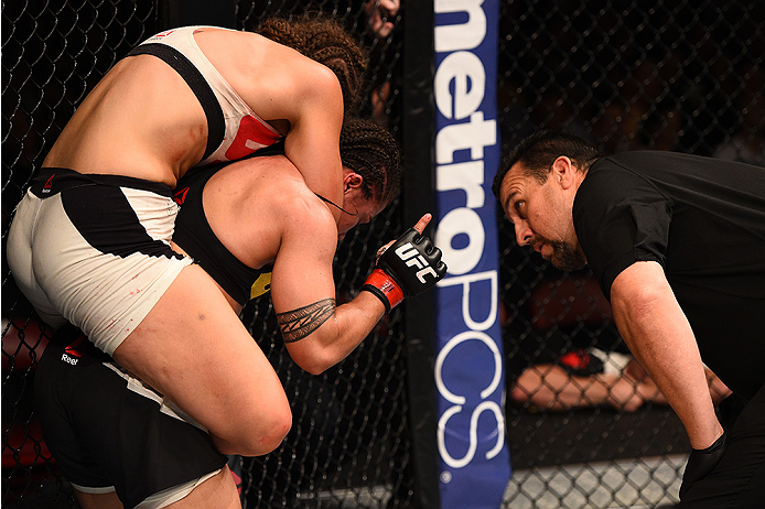 SAN DIEGO, CA - JULY 15:   (R-L) Jessica Andrade of Brazil lets the referee know she is ok while Sarah Moras of Canada attempts to submit her in their women's bantamweight bout during the UFC event at the Valley View Casino Center on July 15, 2015 in San 