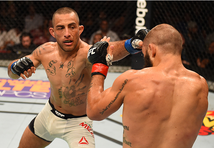 SAN DIEGO, CA - JULY 15:   (L-R) Yaotzin Meza punches Sam Sicilia in their featherweight bout during the UFC event at the Valley View Casino Center on July 15, 2015 in San Diego, California. (Photo by Jeff Bottari/Zuffa LLC/Zuffa LLC via Getty Images)