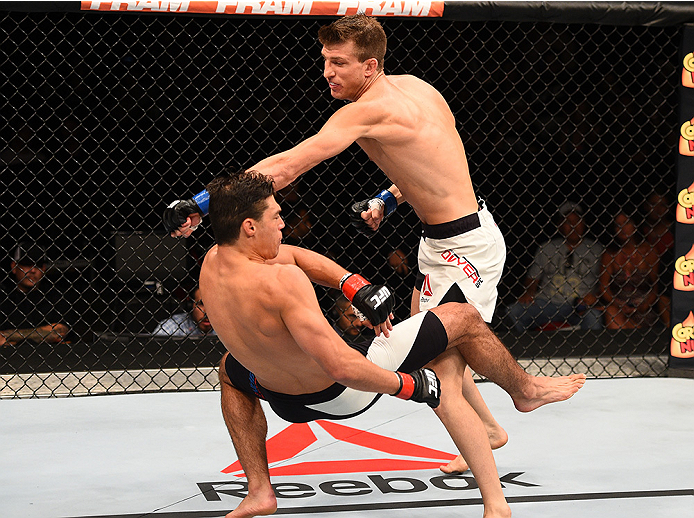 SAN DIEGO, CA - JULY 15:   (R-L) Matt Dwyer of Canada punches Alan Jouban in their welterweight bout during the UFC event at the Valley View Casino Center on July 15, 2015 in San Diego, California. (Photo by Jeff Bottari/Zuffa LLC/Zuffa LLC via Getty Imag