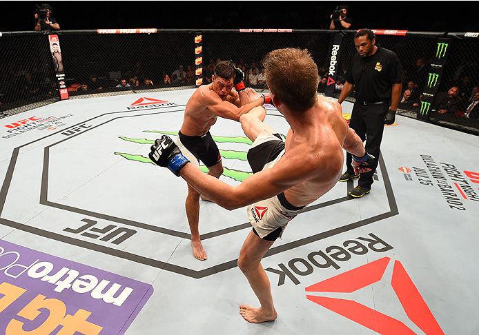 SAN DIEGO, CA - JULY 15:   (R-L) Matt Dwyer of Canada kicks Alan Jouban in their welterweight bout during the UFC event at the Valley View Casino Center on July 15, 2015 in San Diego, California. (Photo by Jeff Bottari/Zuffa LLC/Zuffa LLC via Getty Images