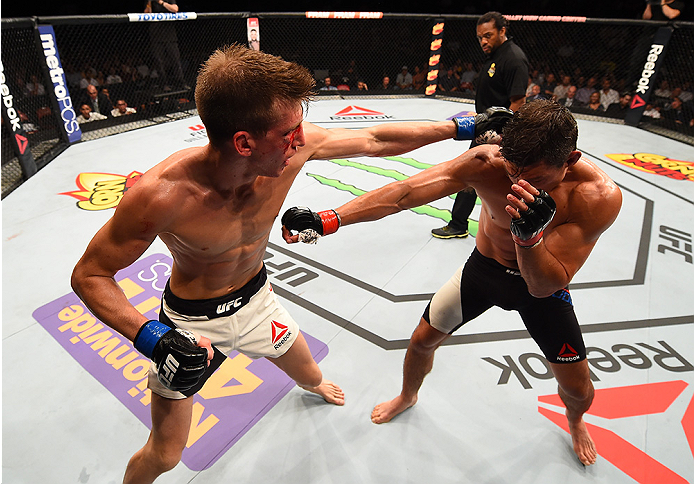 SAN DIEGO, CA - JULY 15:   (L-R) Matt Dwyer of Canada punches Alan Jouban in their welterweight bout during the UFC event at the Valley View Casino Center on July 15, 2015 in San Diego, California. (Photo by Jeff Bottari/Zuffa LLC/Zuffa LLC via Getty Imag