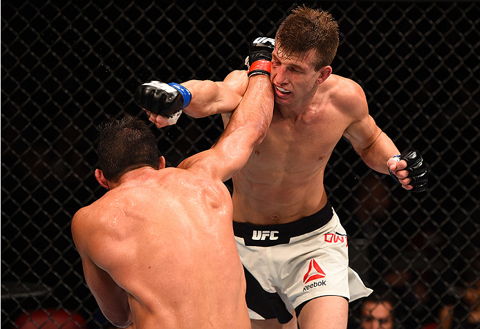 SAN DIEGO, CA - JULY 15:   (L-R) Alan Jouban punches Matt Dwyer of Canada in their welterweight bout during the UFC event at the Valley View Casino Center on July 15, 2015 in San Diego, California. (Photo by Jeff Bottari/Zuffa LLC/Zuffa LLC via Getty Imag