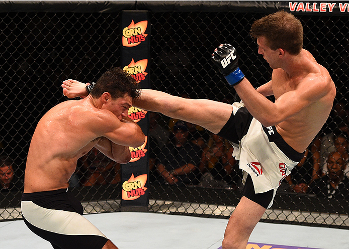 SAN DIEGO, CA - JULY 15:   (R-L) Matt Dwyer of Canada kicks Alan Jouban in their welterweight bout during the UFC event at the Valley View Casino Center on July 15, 2015 in San Diego, California. (Photo by Jeff Bottari/Zuffa LLC/Zuffa LLC via Getty Images