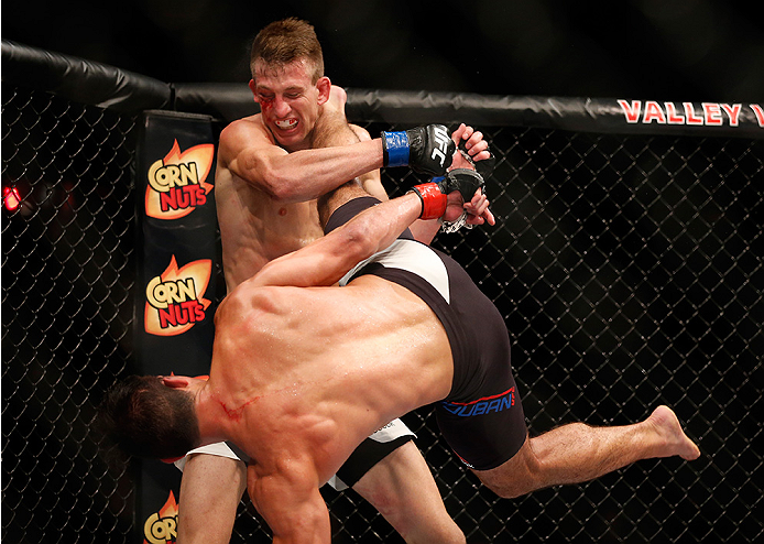 SAN DIEGO, CA - JULY 15:   (R-L) Alan Jouban kicks Matt Dwyer of Canada in their welterweight bout during the UFC event at the Valley View Casino Center on July 15, 2015 in San Diego, California. (Photo by Todd Warshaw/Zuffa LLC/Zuffa LLC via Getty Images