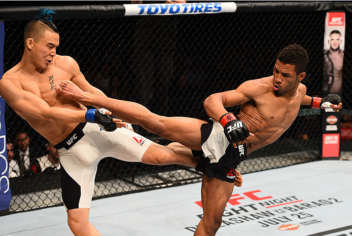 SAN DIEGO, CA - JULY 15: (R-L) Kevin Lee kicks James Moontasri in their lightweight bout during the UFC event at the Valley View Casino Center on July 15, 2015 in San Diego, California. (Photo by Jeff Bottari/Zuffa LLC/Zuffa LLC via Getty Images)