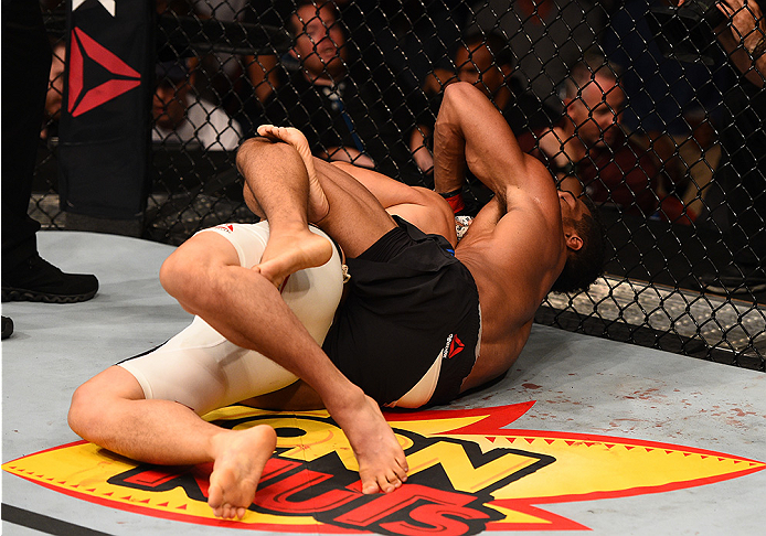 SAN DIEGO, CA - JULY 15:   (R-L) Kevin Lee attempts to submit James Moontasri in their lightweight bout during the UFC event at the Valley View Casino Center on July 15, 2015 in San Diego, California. (Photo by Jeff Bottari/Zuffa LLC/Zuffa LLC via Getty I