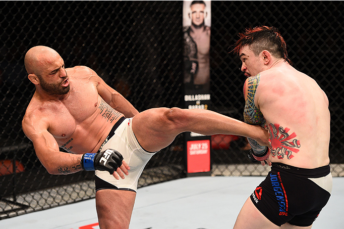 SAN DIEGO, CA - JULY 15:   (L-R) Manny Gamburyan kicks Scott Jorgensen in their flyweight bout during the UFC event at the Valley View Casino Center on July 15, 2015 in San Diego, California. (Photo by Jeff Bottari/Zuffa LLC/Zuffa LLC via Getty Images)