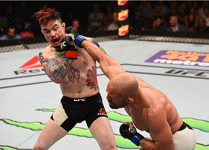 SAN DIEGO, CA - JULY 15:   (R-L) Manny Gamburyan punches Scott Jorgensen in their flyweight bout during the UFC event at the Valley View Casino Center on July 15, 2015 in San Diego, California. (Photo by Jeff Bottari/Zuffa LLC/Zuffa LLC via Getty Images)