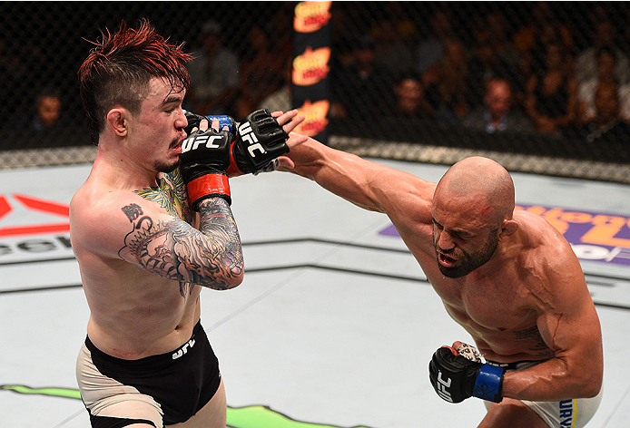 SAN DIEGO, CA - JULY 15:   (R-L) Manny Gamburyan punches Scott Jorgensen in their flyweight bout during the UFC event at the Valley View Casino Center on July 15, 2015 in San Diego, California. (Photo by Jeff Bottari/Zuffa LLC/Zuffa LLC via Getty Images)