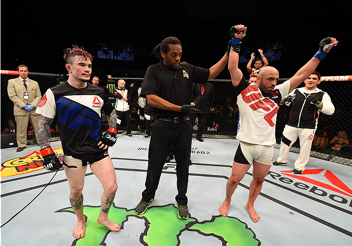 SAN DIEGO, CA - JULY 15:   (R-L) Manny Gamburyan celebrates his victory over Scott Jorgensen in their flyweight bout during the UFC event at the Valley View Casino Center on July 15, 2015 in San Diego, California. (Photo by Jeff Bottari/Zuffa LLC/Zuffa LL