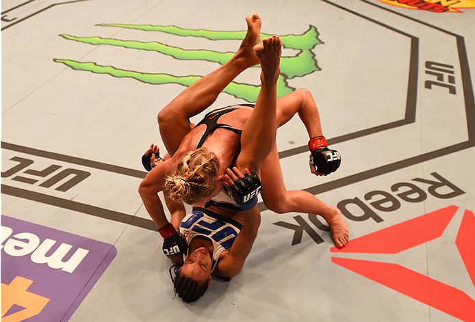 SAN DIEGO, CA - JULY 15: Holly Holm (top) punches Marion Reneau in their women's bantamweight bout during the UFC event at the Valley View Casino Center on July 15, 2015 in San Diego, California. (Photo by Jeff Bottari/Zuffa LLC/Zuffa LLC via Getty Imag