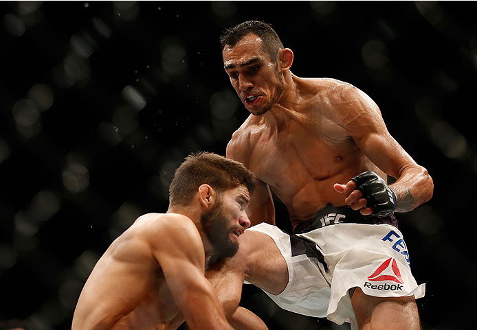 SAN DIEGO, CA - JULY 15:  (R-L) Tony Ferguson throws a flying knee at Josh Thomson in their lightweight bout during the UFC event at the Valley View Casino Center on July 15, 2015 in San Diego, California. (Photo by Todd Warshaw/Zuffa LLC/Zuffa LLC via Ge