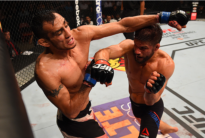 SAN DIEGO, CA - JULY 15:  (R-L) Josh Thomson punches Tony Ferguson in their lightweight bout during the UFC event at the Valley View Casino Center on July 15, 2015 in San Diego, California. (Photo by Jeff Bottari/Zuffa LLC/Zuffa LLC via Getty Images)