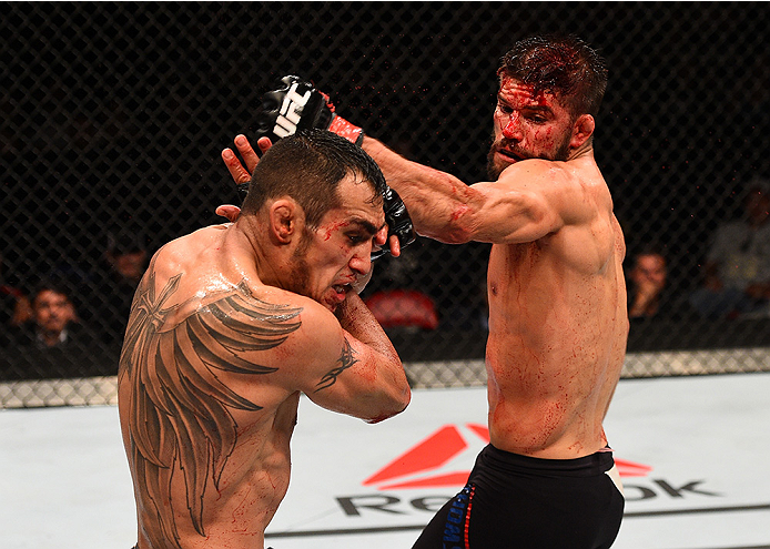 SAN DIEGO, CA - JULY 15: (R-L) Josh Thomson throws a spinning back fist at Tony Ferguson in their lightweight bout during the UFC event at the Valley View Casino Center on July 15, 2015 in San Diego, California. (Photo by Jeff Bottari/Zuffa LLC/Zuffa LLC
