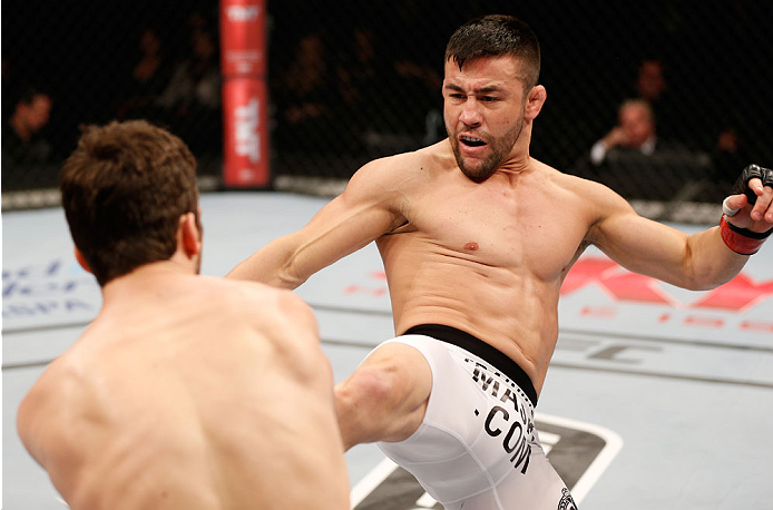 SAO PAULO, BRAZIL - MAY 31: (R-L) Pedro Munhoz kicks Matt Hobar in their bantamweight fight during the UFC Fight Night event at the Ginasio do Ibirapuera on May 31, 2014 in Sao Paulo, Brazil. (Photo by Josh Hedges/Zuffa LLC/Zuffa LLC via Getty Images)