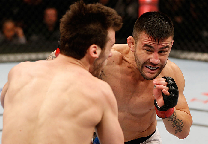 SAO PAULO, BRAZIL - MAY 31: (R-L) Pedro Munhoz punches Matt Hobar in their bantamweight fight during the UFC Fight Night event at the Ginasio do Ibirapuera on May 31, 2014 in Sao Paulo, Brazil. (Photo by Josh Hedges/Zuffa LLC/Zuffa LLC via Getty Images)