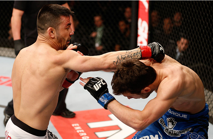 SAO PAULO, BRAZIL - MAY 31: (L-R) Pedro Munhoz punches Matt Hobar in their bantamweight fight during the UFC Fight Night event at the Ginasio do Ibirapuera on May 31, 2014 in Sao Paulo, Brazil. (Photo by Josh Hedges/Zuffa LLC/Zuffa LLC via Getty Images)