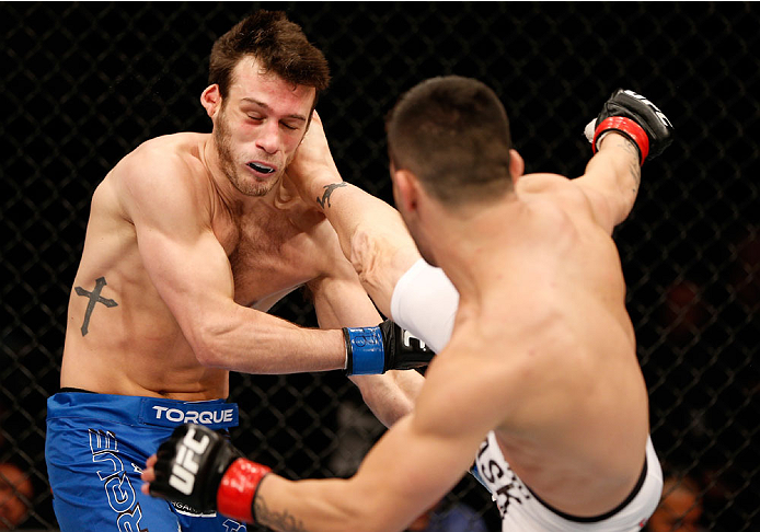 SAO PAULO, BRAZIL - MAY 31: (R-L) Pedro Munhoz kicks Matt Hobar in their bantamweight fight during the UFC Fight Night event at the Ginasio do Ibirapuera on May 31, 2014 in Sao Paulo, Brazil. (Photo by Josh Hedges/Zuffa LLC/Zuffa LLC via Getty Images)