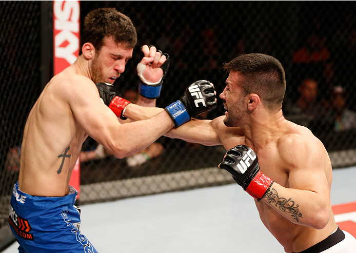 SAO PAULO, BRAZIL - MAY 31: (R-L) Pedro Munhoz punches Matt Hobar in their bantamweight fight during the UFC Fight Night event at the Ginasio do Ibirapuera on May 31, 2014 in Sao Paulo, Brazil. (Photo by Josh Hedges/Zuffa LLC/Zuffa LLC via Getty Images)