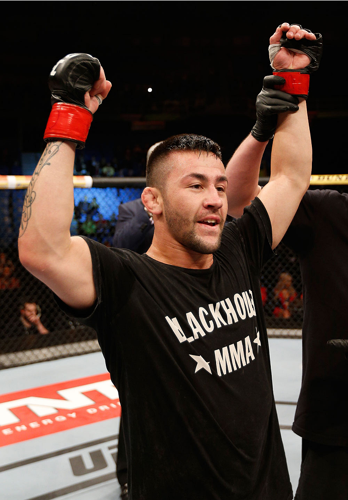 SAO PAULO, BRAZIL - MAY 31: Pedro Munhoz reacts after his TKO victory over Matt Hobar in their bantamweight fight during the UFC Fight Night event at the Ginasio do Ibirapuera on May 31, 2014 in Sao Paulo, Brazil. (Photo by Josh Hedges/Zuffa LLC/Zuffa LLC