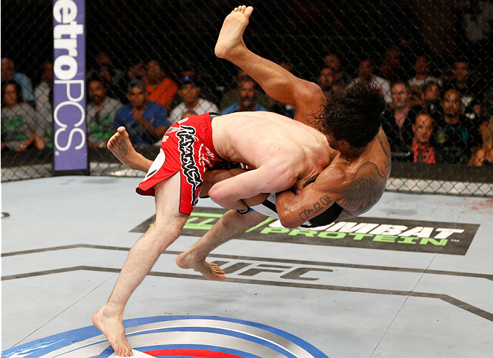 ALBUQUERQUE, NM - JUNE 07:  (L-R) Rustam Khabilov takes down Benson Henderson in their lightweight fight during the UFC Fight Night event at Tingley Coliseum on June 7, 2014 in Albuquerque, New Mexico.  (Photo by Josh Hedges/Zuffa LLC/Zuffa LLC via Getty 