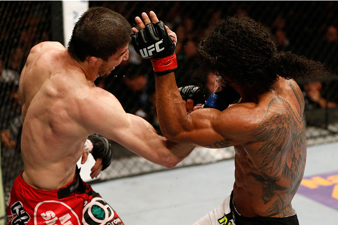 ALBUQUERQUE, NM - JUNE 07:  (L-R) Rustam Khabilov punches Benson Henderson in their lightweight fight during the UFC Fight Night event at Tingley Coliseum on June 7, 2014 in Albuquerque, New Mexico.  (Photo by Josh Hedges/Zuffa LLC/Zuffa LLC via Getty Ima