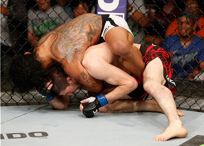 ALBUQUERQUE, NM - JUNE 07:  (L-R) Benson Henderson secures a rear choke submission against Rustam Khabilov in their lightweight fight during the UFC Fight Night event at Tingley Coliseum on June 7, 2014 in Albuquerque, New Mexico.  (Photo by Josh Hedges/Z