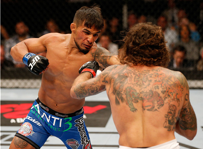SAN JOSE, CA - JULY 26: (L-R) Dennis Bermudez punches Clay Guida in their featherweight bout during the UFC Fight Night event at SAP Center on July 26, 2014 in San Jose, California. (Photo by Josh Hedges/Zuffa LLC/Zuffa LLC via Getty Images)